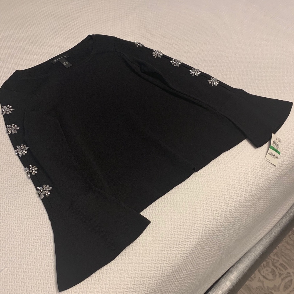 NWT Black top with Rhinestones on sleeves.